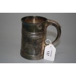 A George III tankard, tapering cylindrical with reeded bands to body, leaf capped 'D' shaped handle,