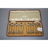 James Dixon, a cased set of twelve silver coffee spoons and tongs, each with pierced handle,
