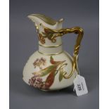 A Royal Worcester jug of baluster form with entwined tendril handle on a florally decorated ivory