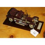 An early 20th century maroon painted lead model of a 1907 Rolls Royce 40 HP Ghost, with folding