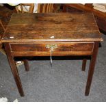 A mid 18th century oak lowboy, the planked top with a moulded edge, over frieze drawer with