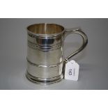 Welby of London, a silver cylindrical tankard with scroll handle and reeded bands, London 1935,