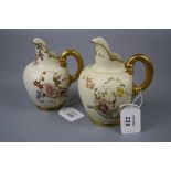 Two Royal Worcester flat back jugs, each florally decorated on an ivory and gilt ground, design