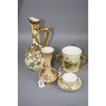 A Royal Worcester tea cup and saucer, No 4158, together with a waisted neck twin handled vase,
