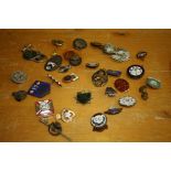 A collection of approximately thirty-three pin and other badges, various including Oddfellows,