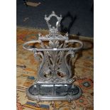 A Victorian cast iron stick stand with twin seahorse scrolled back and drip pan. 80 x 55cm