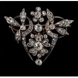 A Belle Epoque diamond brooch, pendant shield shaped, with central foliate diamond cluster within