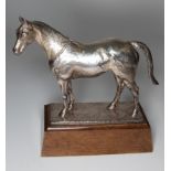 Asprey, a silver model of a horse, the realistically modelled animal on textured rectangular base,