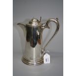 Deakin and Harrison, a silver coffee pot and cover with domed lid, scallop thumb piece and elongated