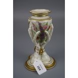 A Royal Worcester amphora and eagle talon form vase, decorated with summer flowers on an ivory and