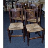 A set of four 19th century oak dining chairs, each having ball finials, florally carved rails and