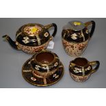 A late Victorian Imari ware part tea service, comprising teapot and stand, hot water pot, cream