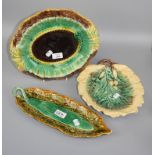 A collection of 19th century majolica ware plates, bread baskets and other similar items