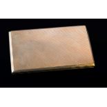 A 9ct gold cigarette case, rounded rectangular engine turned push button thumbpiece, London 1938
