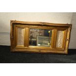 A gilt composite overmantel mirror, the beaded bell flower decorated frame enclosing a rectangular