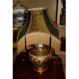 A contemporary ceramic table lamp modelled as a gilt floral relief crackle gazed spice jar and cover