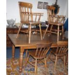 A Victorian-style light oak farmhouse kitchen dining table, together with a set of six lathe back