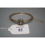 A late Victorian diamond cluster bangle, the central, openwork foliate cluster, with detachable