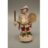 An early 19th century English porcelain figure of Falstaff, typically modelled standing with sword