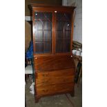 An Edwardian mahogany bureau bookcase, the moulded and dentil cornice over a pair of shaped barred