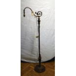 A patinated Victorian style brass library standard lamp