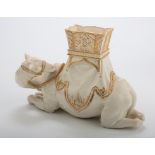 A Hadley Worcester flower vase, modelled as a preening recumbent camel with howdah, on an ivory