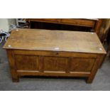 A small 18th century oak coffer, the planked top with moulded edge over panel sides and three