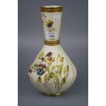 A Royal Worcester vase, with conical neck and wrythen body, decorated with spring flowers on an