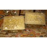 Two early 20th century embossed brass coal boxes, each with hinged sloping lid, decorated with