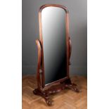 A Victorian style mahogany cheval mirror, the channelled frame enclosing an arched rectangular plate