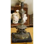 A heavy cast and gilt metal table lamp base with young satyr supports over a black marble base, 43cm