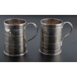 I.W. a pair of silver cylindrical mugs, each with reeded entwined handle and banded body, London