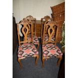 A set of four early 19th century walnut side chairs, with carved cabriole supports