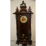 A 19th century walnut Vienna wall clock, the case with prancing horse surmount over a glazed door