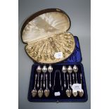 A cased set of twelve Continental silver and gilt coffee spoons and tongs, each with hoof handle,