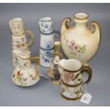 Six pieces of Royal Worcester porcelain, including a twin handled amphora vase, two conical jugs,