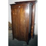 A 19th century mahogany gentlemans bow front dressing cupboard, with moulded doors and splay feet,