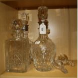A pair of 20th century collared mallet form cut crystal spirit decanter with seal shaped pommel
