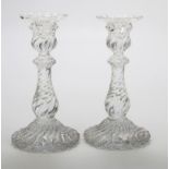 A pair of 20th century Baccarat moulded glass wrythen form table candlesticks, each on a spreading