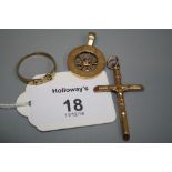 A 9ct gold zodiac pendant, a crucifix pendant and a 9ct gold buckle ring