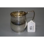 An early 19th century christening mug, of baluster form, with swept angular handle and ribbed