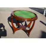 An early 20th century American mahogany card/dining table, the circular top lined with baize