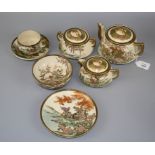 An early 20th century Japanese Satsuma teaset painted with birds, shrubs and grasses in river