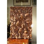 A carved Balinese softwood panel, well detailed with a Barong Dance, accompanied by a Gamelan