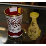 A Bohemian ruby flash and milk glass beaker with gilt rim, hand painted rose bands and cut-away