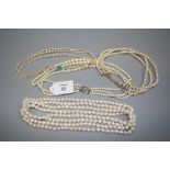 An opera length freshwater pearl necklace, together with three simulated pearl necklaces