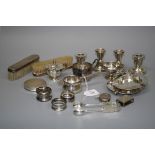 A mixed lot of small silver items, including two pairs of squat candlesticks, a pair of silver