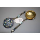 A pair of late 19th century Russian silver gilt and cloisonné serving spoons, each with knop