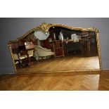 A very large gilt frame saloon mirror, with carved decoration, 260cm wide