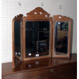 A 19th century pine three glass folding toilet mirror, with fret carved surmount and silvered